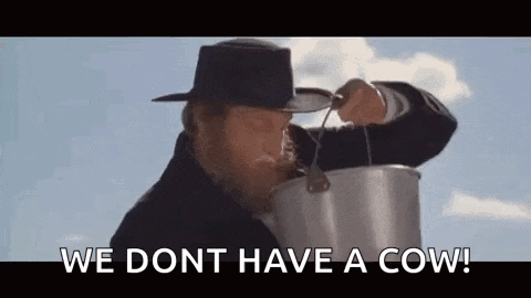 Woody Harrilson's character from Kingpen, drinking from a bucket after "milking" a bull. The caption reads: "We don't have a cow!" 